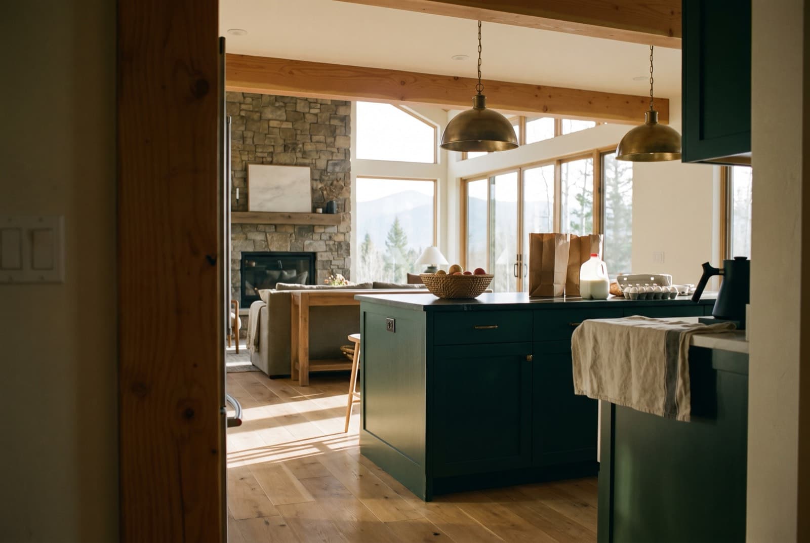 A stocked mountain kitchen and great room seen from the doorway, empty and ready for guests